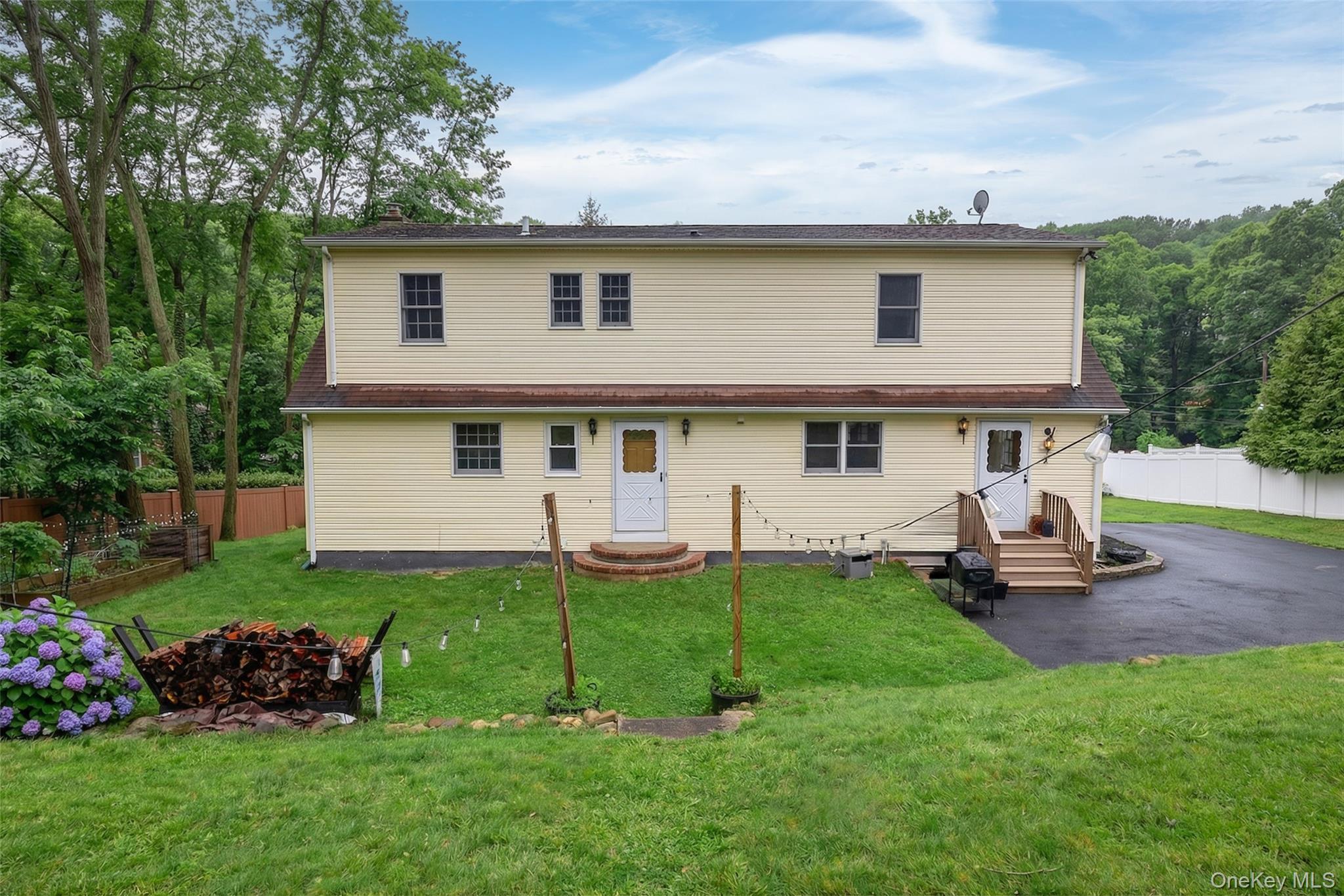 223 Bread And Cheese Hollow Road Northport, NY 11768 - Photo 28 of 32 a view of a house with a backyard and porch