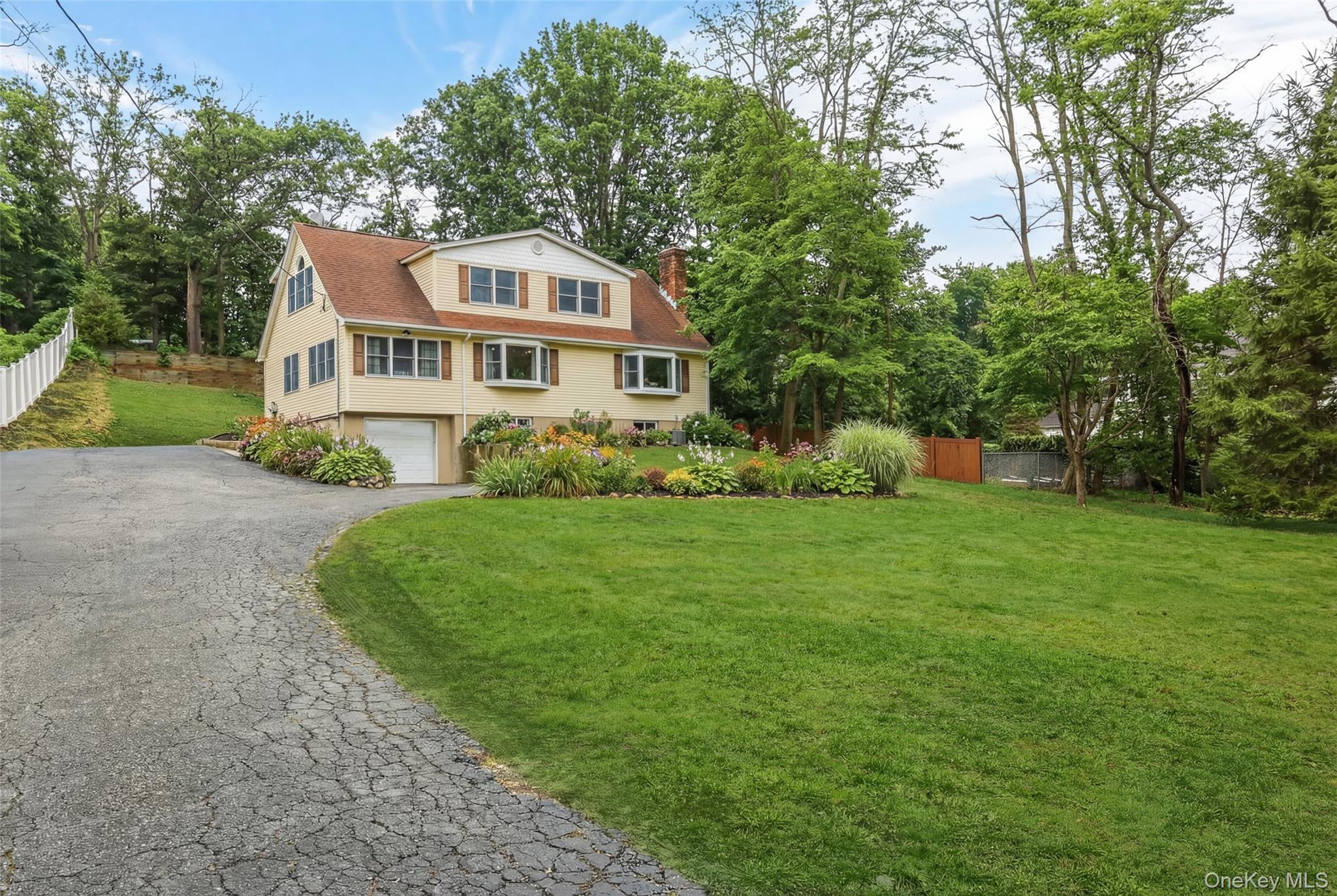 223 Bread And Cheese Hollow Road Northport, NY 11768 - Photo 3 of 32 a front view of a house with garden