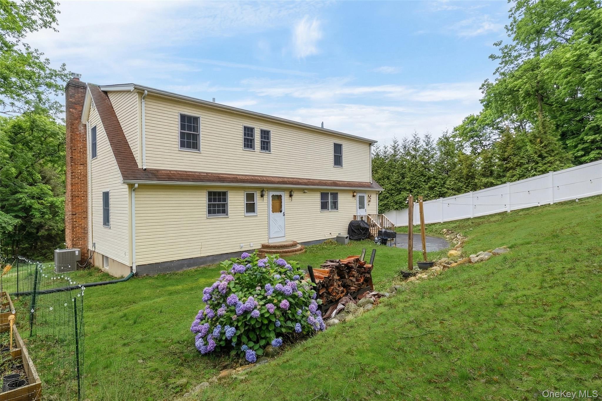 223 Bread And Cheese Hollow Road Northport, NY 11768 - Photo 32 of 32 a front view of house with a garden