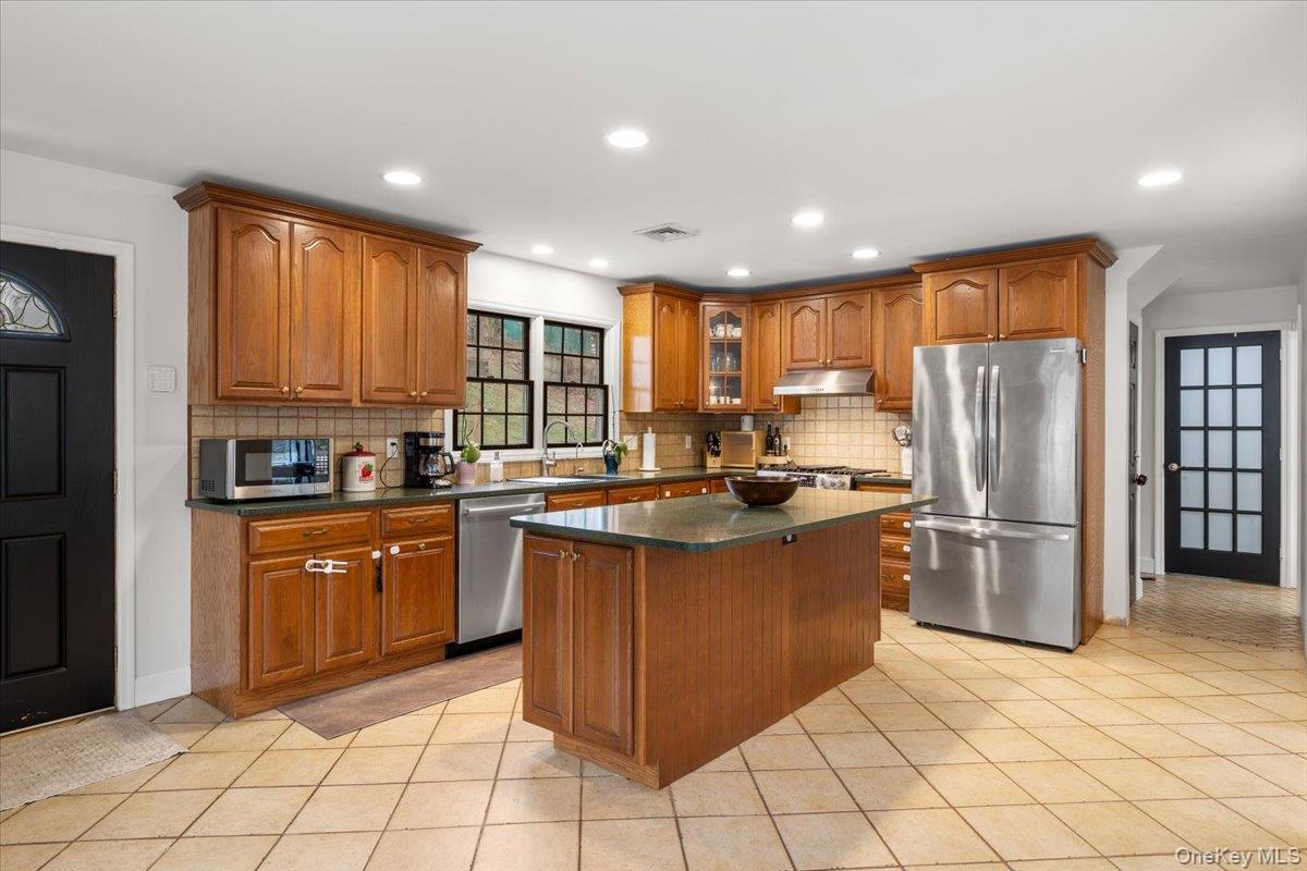 223 Bread And Cheese Hollow Road Northport, NY 11768 - Photo 4 of 32 a kitchen with stainless steel appliances granite countertop a refrigerator and a sink