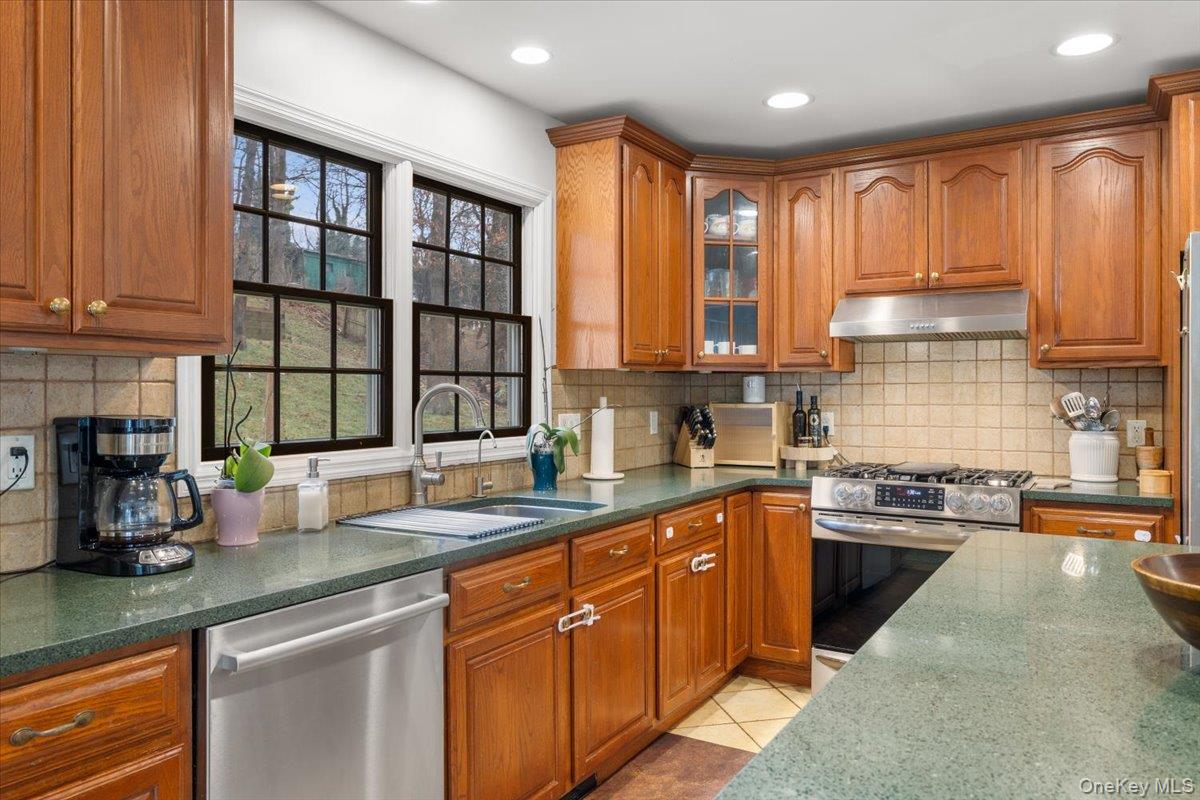 223 Bread And Cheese Hollow Road Northport, NY 11768 - Photo 5 of 32 a kitchen with stainless steel appliances granite countertop a stove sink and cabinets