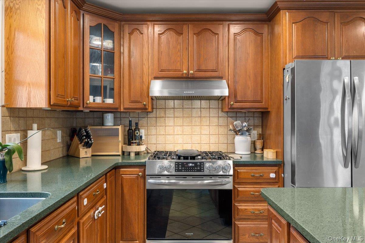 223 Bread And Cheese Hollow Road Northport, NY 11768 - Photo 6 of 32 a kitchen with stainless steel appliances granite countertop a stove a refrigerator and a sink