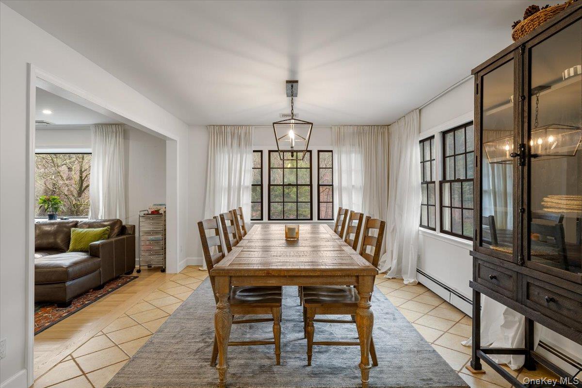 223 Bread And Cheese Hollow Road Northport, NY 11768 - Photo 7 of 32 a view of a dining room with furniture window and wooden floor