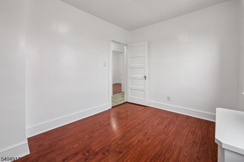 167 Silver Avenue, Unit 3 Hillside, NJ 07205 - Photo 6 of 15 a view of an empty room with wooden floor