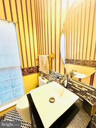 a bathroom with a granite countertop sink and a shower