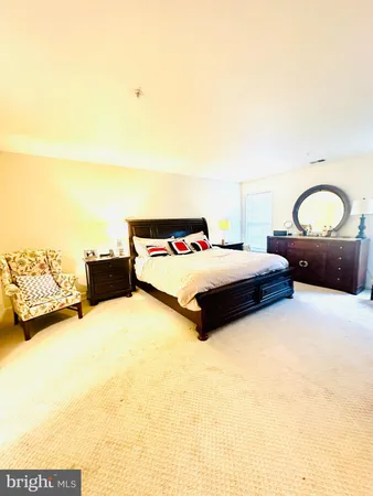 a bedroom with a bed and a lamp