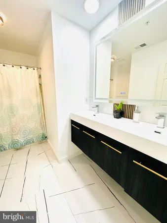 a en suite bathroom with a sink double vanity and a mirror