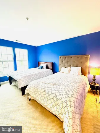 a bedroom with a bed and a night stand