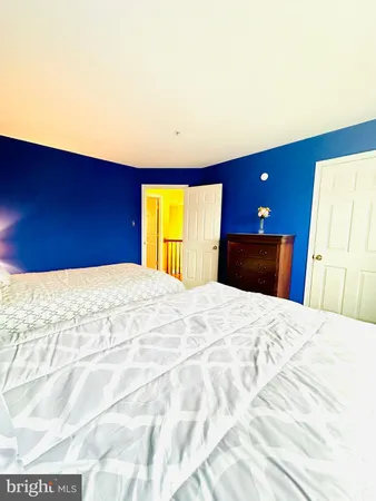 a bedroom with a bed and a lamp