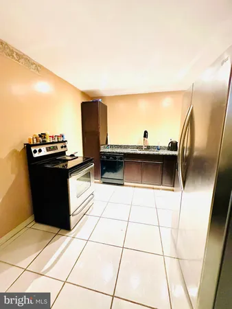a bathroom with a granite countertop sink a toilet a mirror and shower