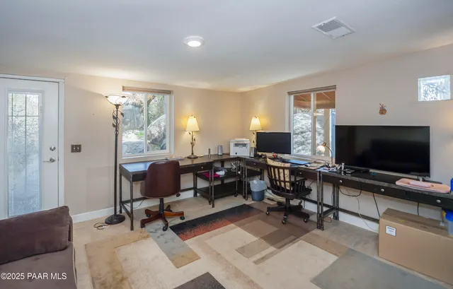 a view of a livingroom with workspace and a window