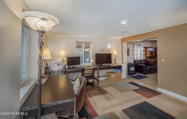 a view of a livingroom with furniture and a flat screen tv