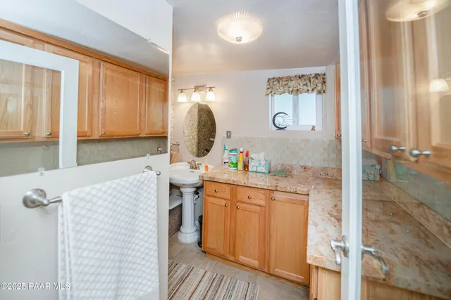 a bathroom with a sink vanity and a mirror