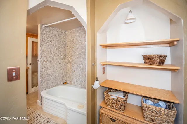 a bathroom with a bathtub and shower