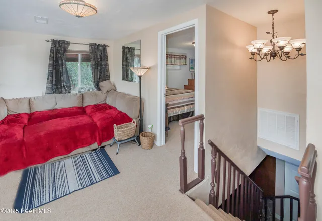 a view of a bedroom with furniture and wooden floor