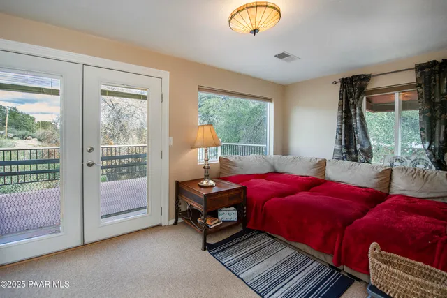 a living room with furniture a large window