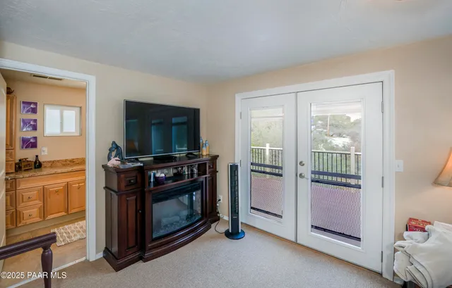 a kitchen with a stove and a flat screen tv