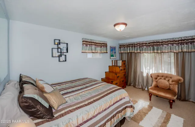 a bedroom with a bed and a couch