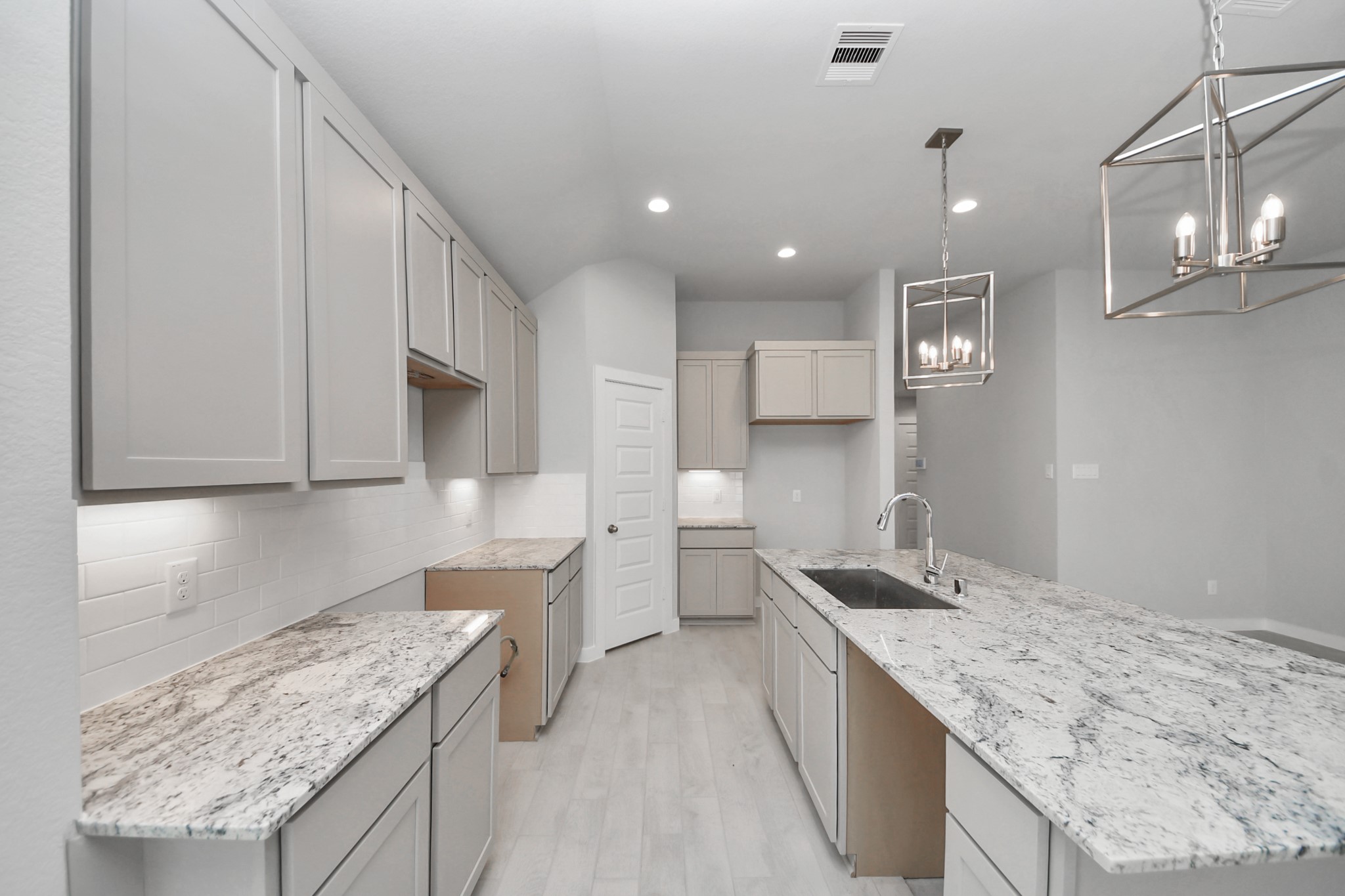 24518 Broad Park Spring, TX 77373 - Photo 15 of 29 Discover another perspective of this stunning kitchen, generously appointed with an abundance of counter space. Sample photo of completed home with similar floor plan. Actual colors and selections may vary.