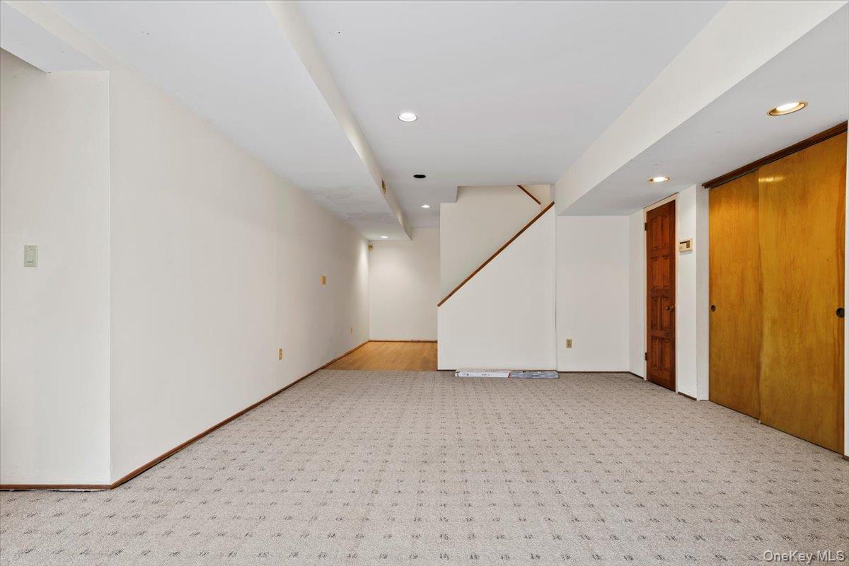 88 Farm Lake Cres Road Chappaqua, NY 10514 - Photo 16 of 22 an empty room with wooden floor and windows