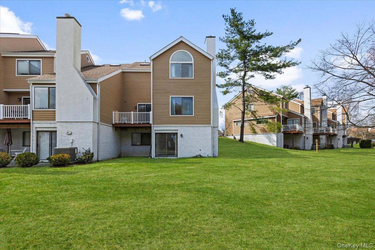 88 Farm Lake Cres Road Chappaqua, NY 10514 - Photo 19 of 22 a front view of a house with a garden