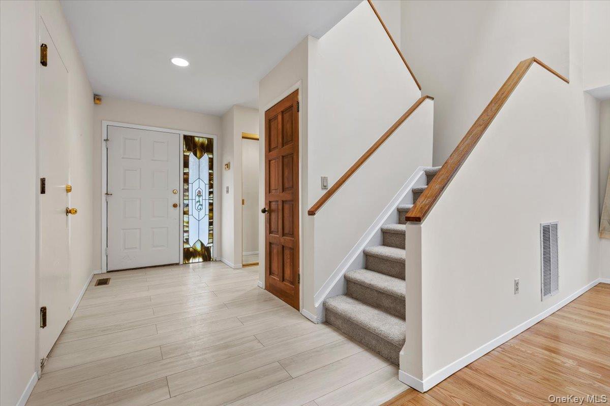 88 Farm Lake Cres Road Chappaqua, NY 10514 - Photo 2 of 22 a view of entryway with stairs and wooden floor