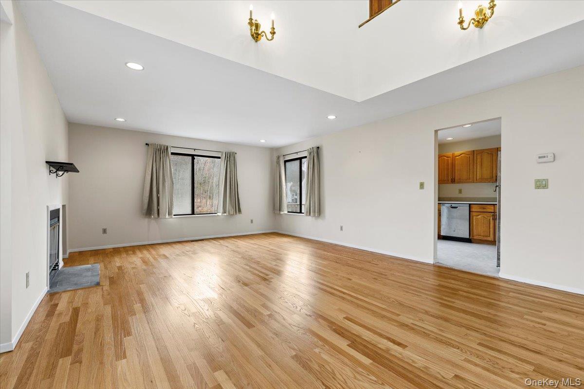 88 Farm Lake Cres Road Chappaqua, NY 10514 - Photo 5 of 22 a view of empty room with wooden floor and fan