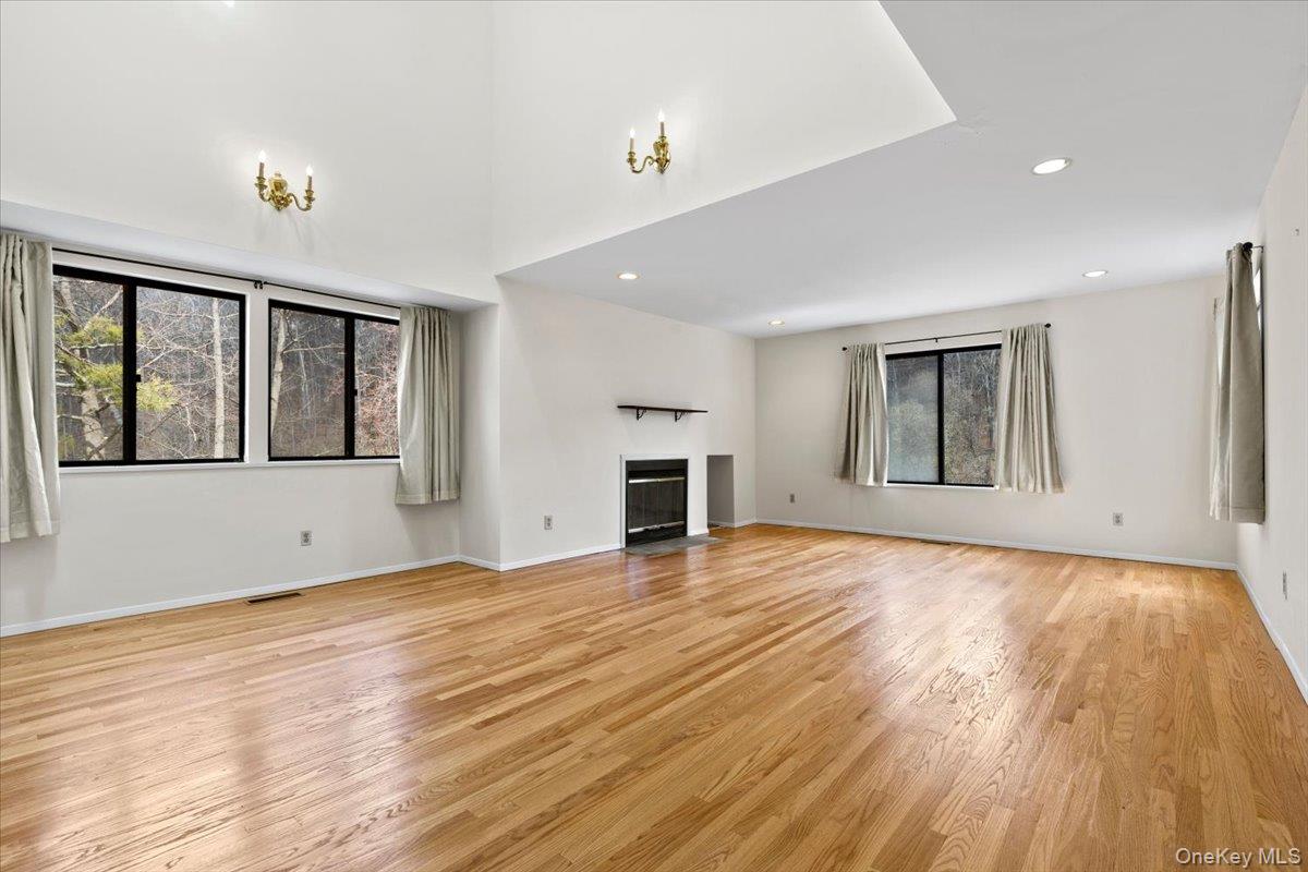 88 Farm Lake Cres Road Chappaqua, NY 10514 - Photo 6 of 22 a view of empty room with wooden floor and fireplace