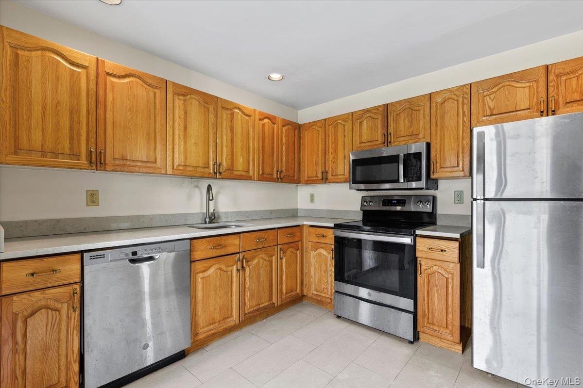 88 Farm Lake Cres Road Chappaqua, NY 10514 - Photo 8 of 22 a kitchen with stainless steel appliances granite countertop a refrigerator stove a sink and dishwasher