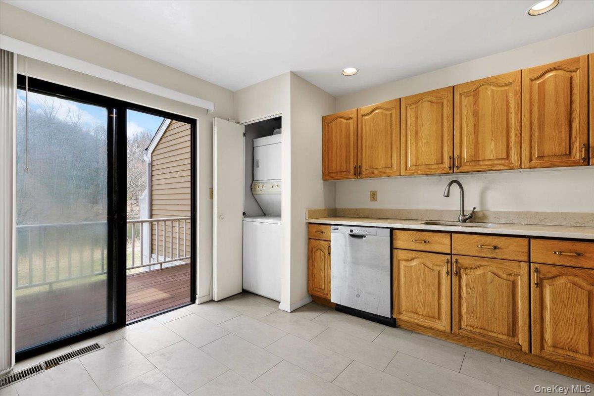 88 Farm Lake Cres Road Chappaqua, NY 10514 - Photo 9 of 22 a kitchen with white cabinets and a refrigerator