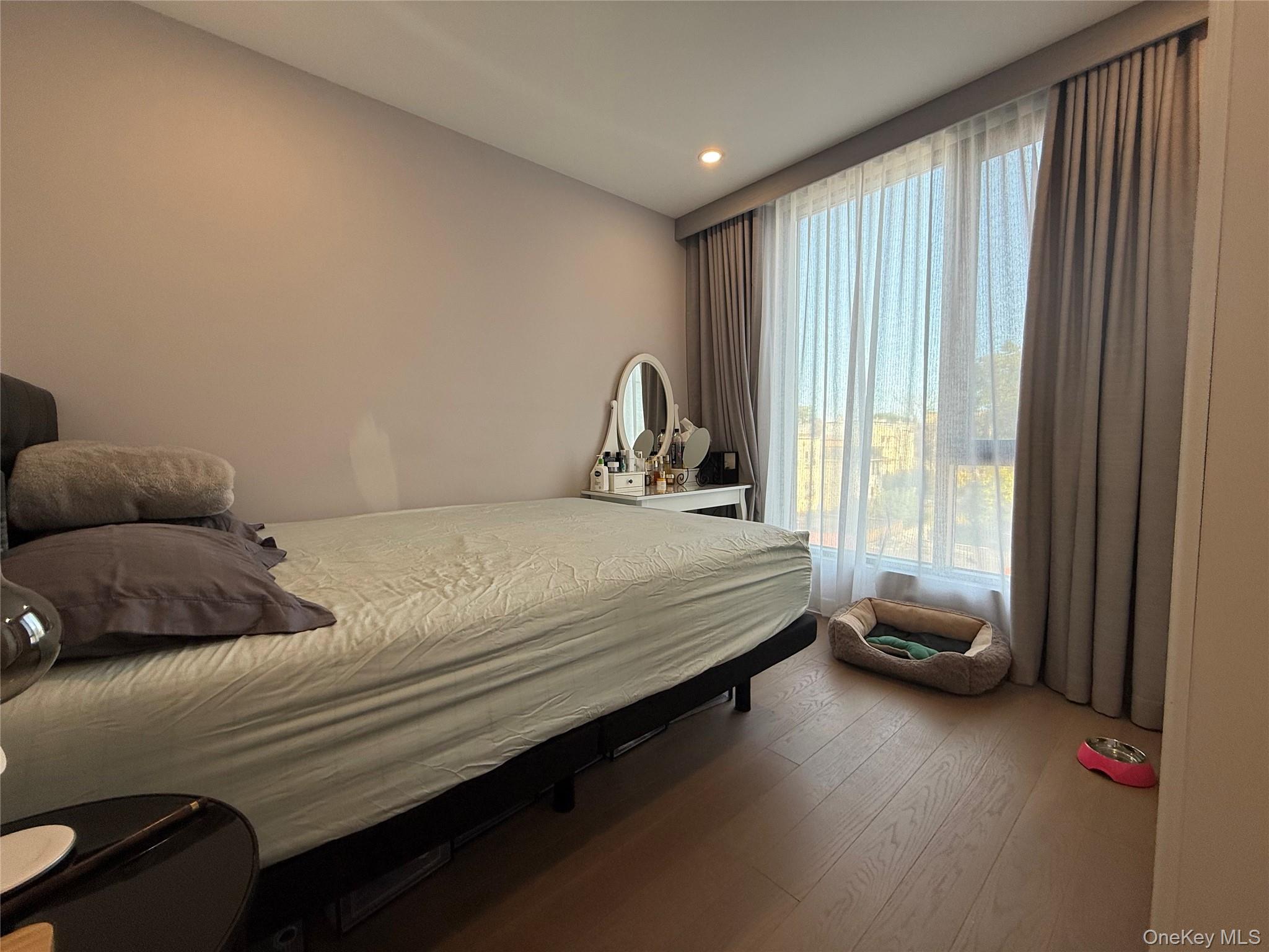 32-58 105th Street, Unit 4A Queens, NY 11369 - Photo 5 of 8 a bedroom with a bed and a window