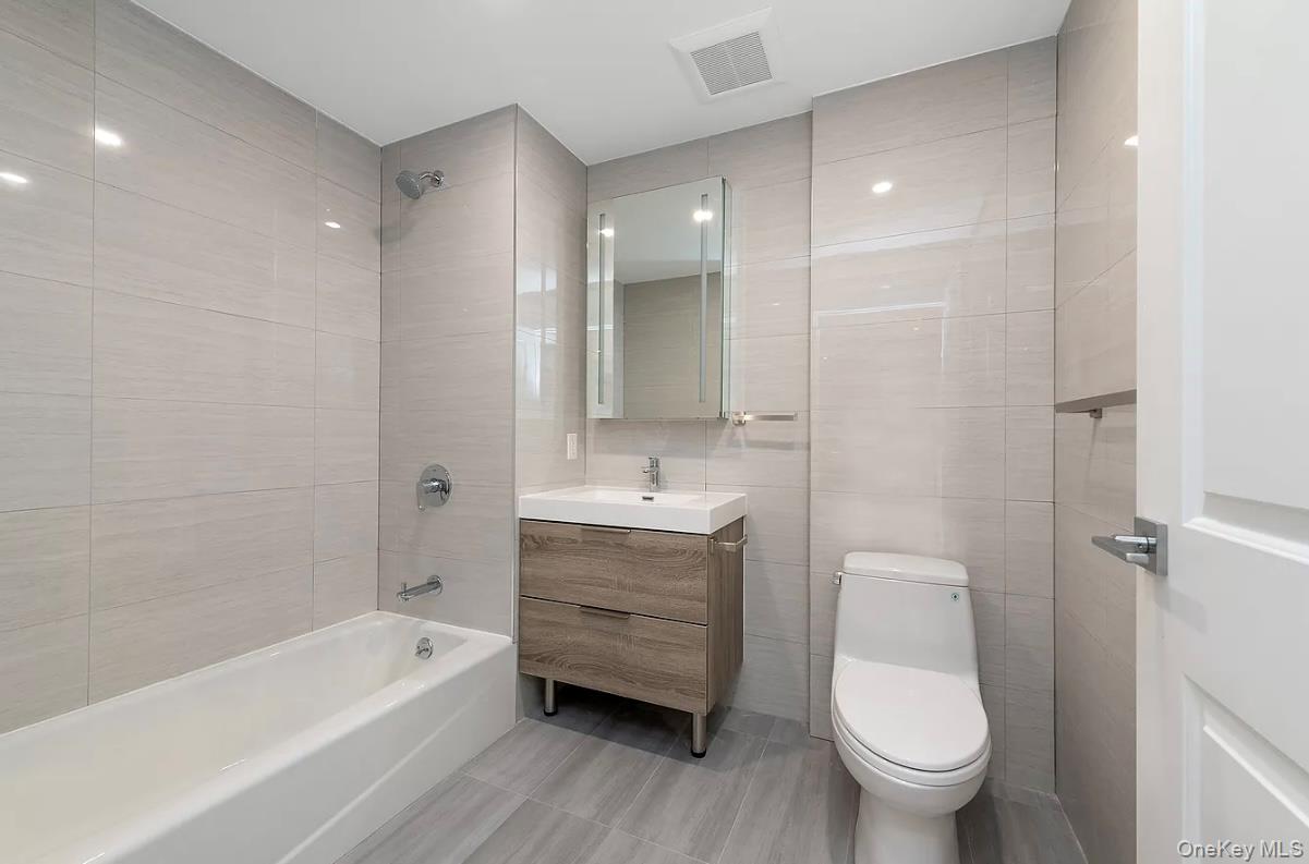 32-58 105th Street, Unit 4A Queens, NY 11369 - Photo 6 of 8 a bathroom with a sink toilet and bathtub