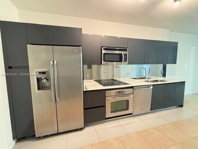 31 Southeast 6th Street, Unit 1804 Miami, FL 33131 - Photo 2 of 15 a kitchen with stainless steel appliances granite countertop a refrigerator and a sink