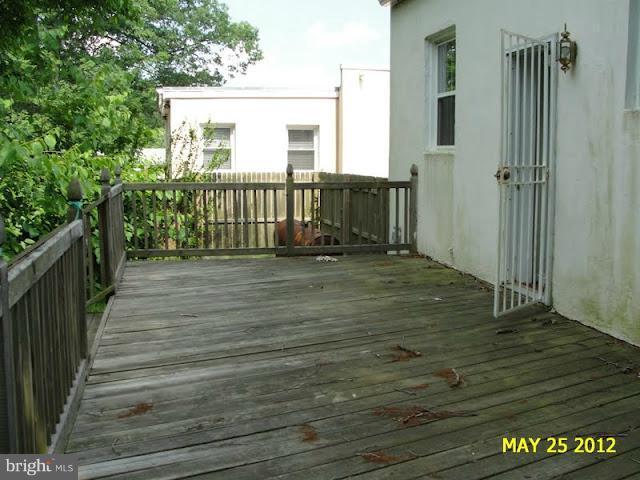 9214 Annapolis Road Lanham, MD 20706 - Photo 22 of 30 a view of a porch with wooden floor and fence