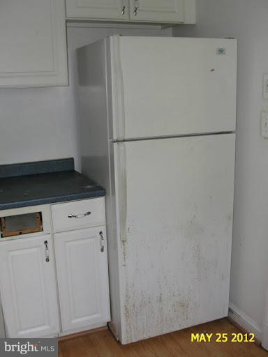 9214 Annapolis Road Lanham, MD 20706 - Photo 23 of 30 a view of a refrigerator in kitchen and an empty room