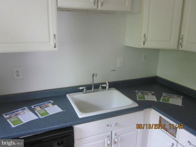 9214 Annapolis Road Lanham, MD 20706 - Photo 29 of 30 a kitchen with a sink cabinets and utility