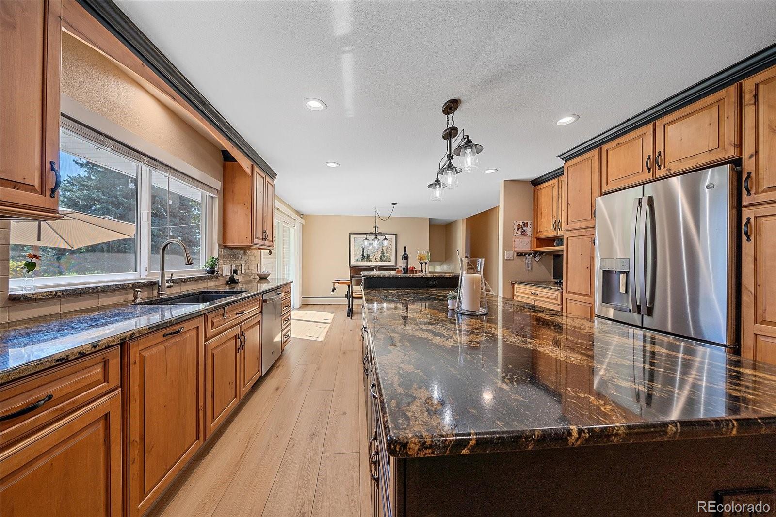 930 Reed Court Lakewood, CO 80214 - Photo 9 of 41 a kitchen with stainless steel appliances granite countertop a refrigerator a sink and a stove