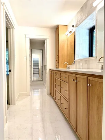 a spacious bathroom with a double vanity sink a large mirror and a bathtub