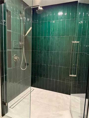 a bathroom with a shower and a sink