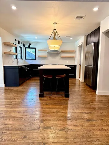 a living room with fireplace furniture and a wooden floor