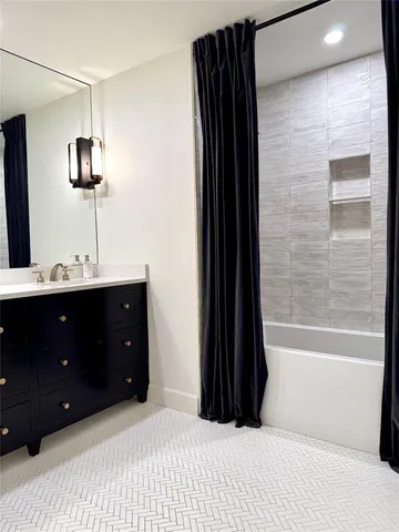 a bathroom with a bathtub and a sink