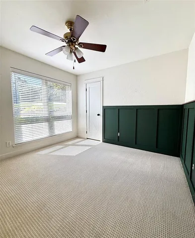 a view of a livingroom with a ceiling fan and window