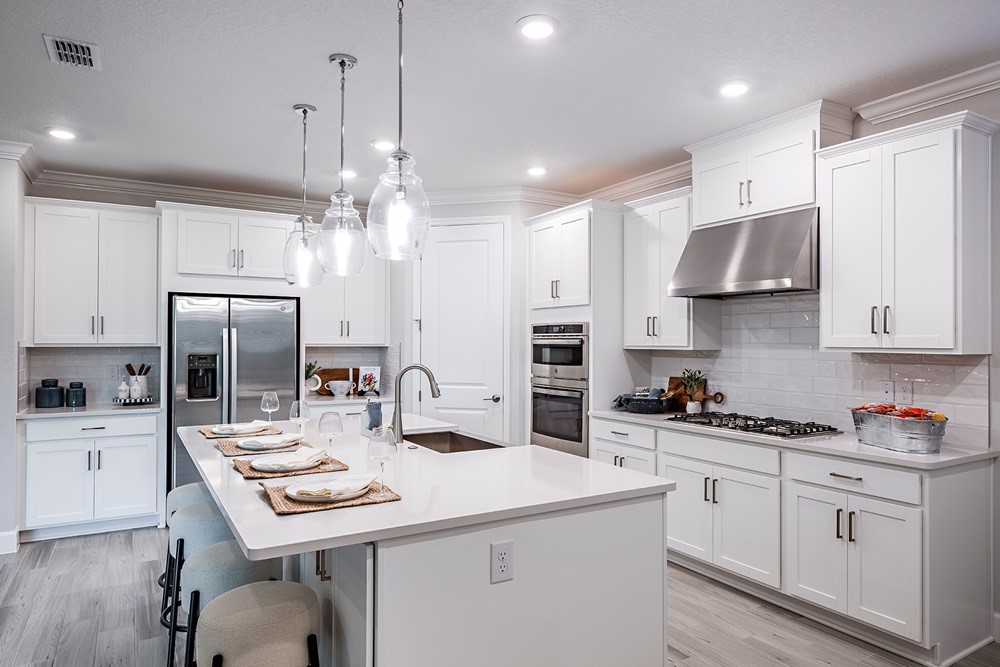 86646 Swift Launch Path Yulee, FL 32097 - Photo 4 of 30 a kitchen that has a lot of cabinets a sink and appliances