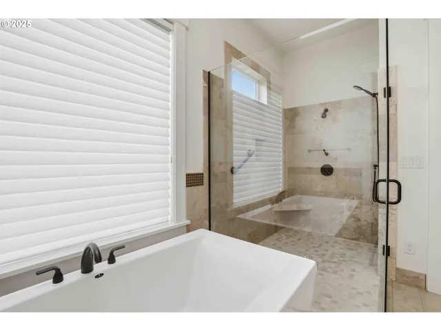 a bathroom with a tub shower and sink