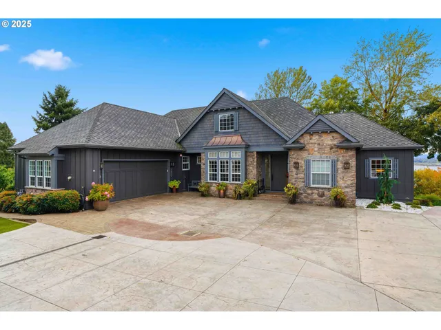 a front view of a house with a garden and patio