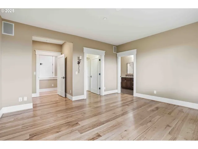 a view of an empty room and wooden floor