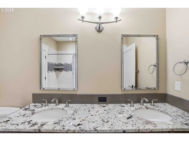 a bathroom with a granite countertop sink mirror and vanity