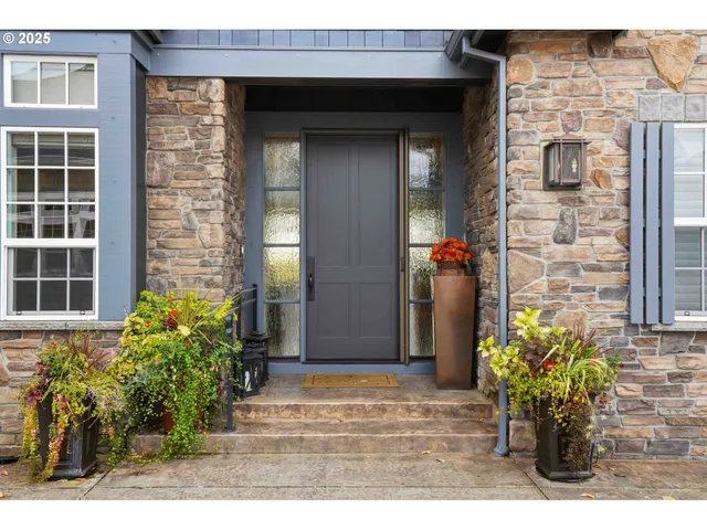 a couple of potted plants in front of door