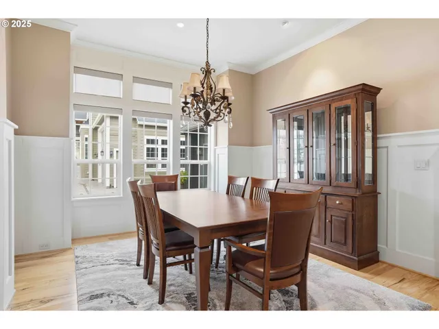 a dining room with furniture window and wooden floor