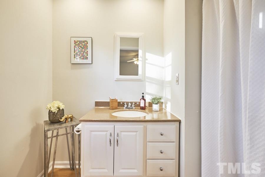 5908 Newhall Road Durham, NC 27713 - Photo 14 of 23 a bathroom with a sink vanity and mirror